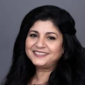 a person with long hair smiling for the camera